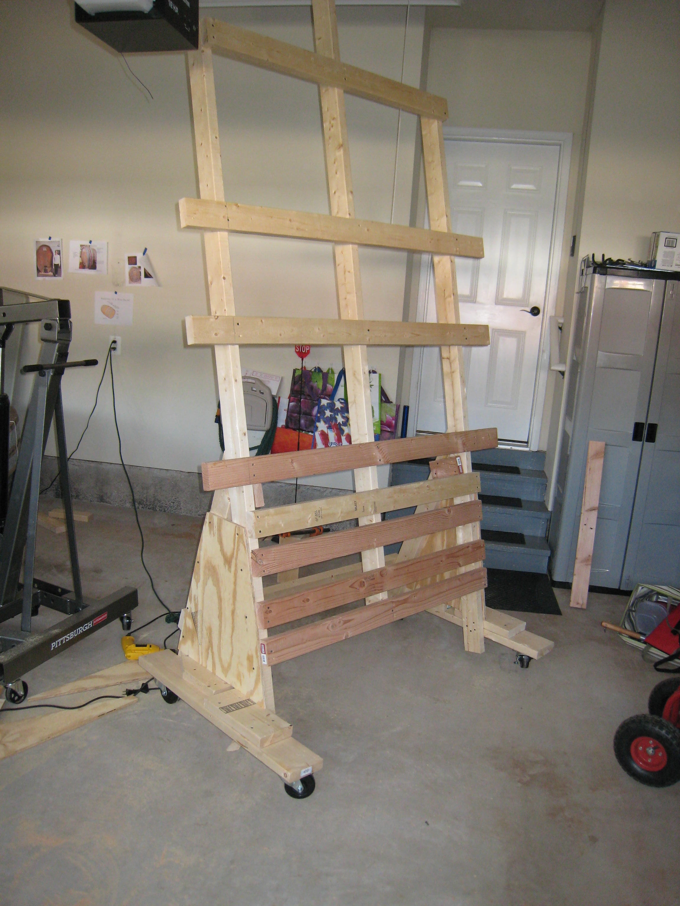 A custom-built wooden carving rack in the garage, built to hold the large wine cask end during carving