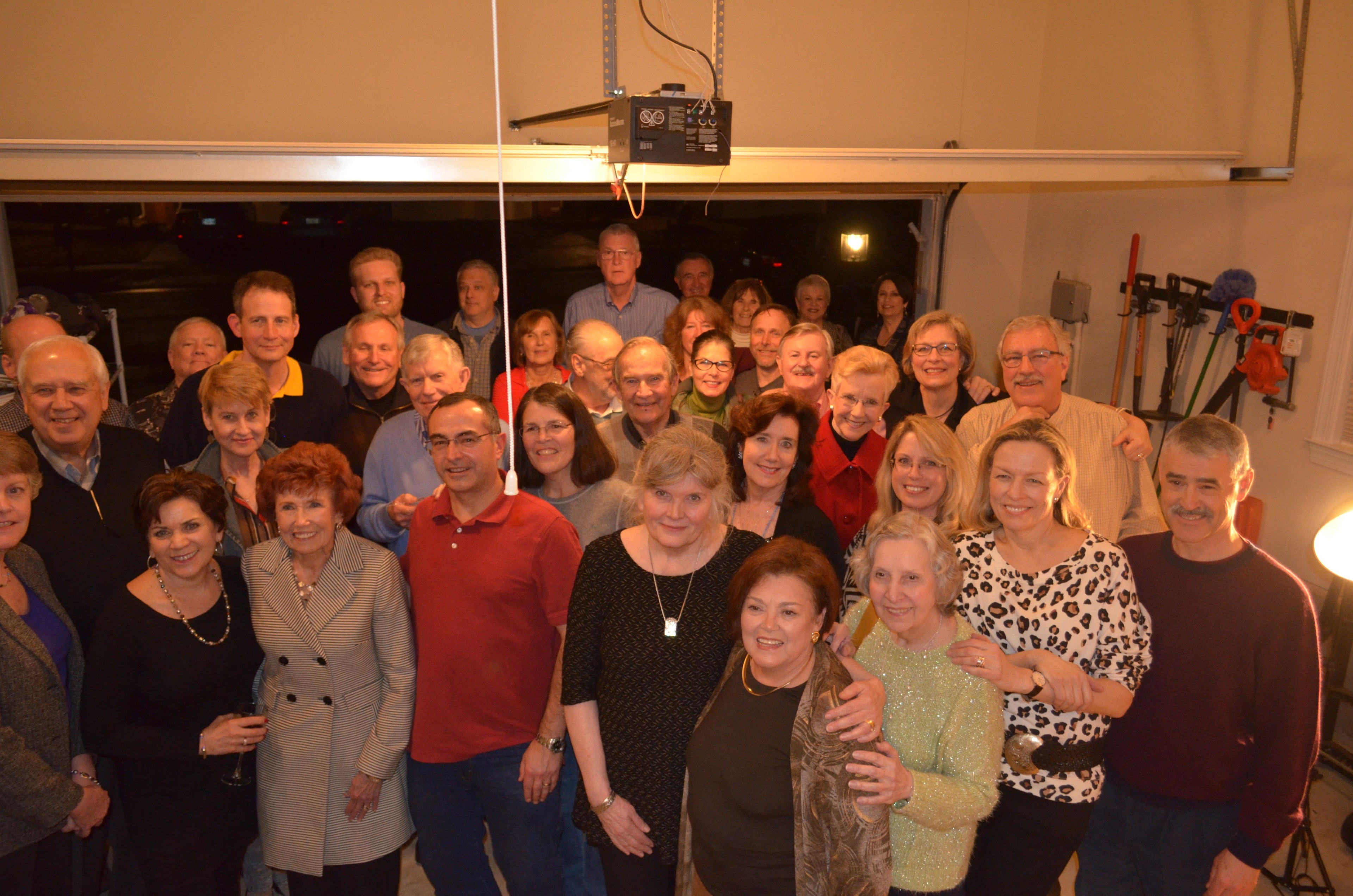 A large group of neighbors and friends gathered in the garage for the unveiling party — the first Big Barrel Party